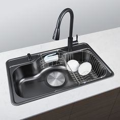 a kitchen sink with two dishes in it