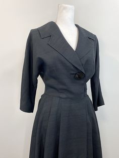 "Elegant black raw silk dress with great 1950s details. Lovely silhouette with one large button (and a bound buttonhole!) on the bodice as well as snaps and hooks inside. The collar and lapel are wide and fantastic. 3/4 dolman sleeve. Waist seam with pleats at the side front and back panels but flat in the front. The lining is a cheerful pale yellow silk. No label, handmade. Condition is great. The lining has some stains and discoloration as well as holes from wear and age under each underarm. R Fitted Vintage 1950s Dress For Workwear, 1950s Fitted Vintage Dress For Work, Fitted 1950s Vintage Dress For Work, 1950s Style Fitted Vintage Dress For Work, 1950s Vintage Dress For Work, 1950s Vintage Dress With Buttons For Formal Occasions, 1950s Style Formal Dresses With Buttons, 1950s Style Buttoned Dresses For Work, Vintage Formal Dress With Box Pleat