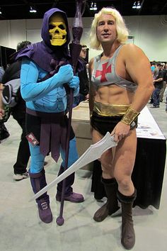 two men in costumes standing next to each other with swords and masks on their faces