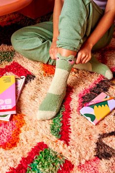 Introducing Moss the Frog Fuzzy Sock - the perfect companion for cozy nights in! Made with soft, fuzzy material, these socks will keep your feet warm and toasty all winter long. Plus, they feature a fun and playful design of our beloved Moss the Frog. Slip on a pair and hop into comfort! Tiny Protectors, Frog Socks, Nature Inspired Accessories, Cute Stockings, Skating Dress, Fuzzy Socks, Cozy Gift, Affordable Gifts, The Frog