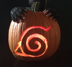 a pumpkin carved to look like an avatar from avatar with the letter o on it