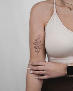 a woman with a flower tattoo on her arm