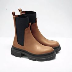 Crafted from genuine leather, these calf-length Chelsea boots are designed for both comfort and fashion. With an elastic band at the top, they offer a secure and snug fit while ensuring ease of wear. A comfortable and durable sole makes them perfect for all-day wear, while a stretchy upper provides comfort on the move and adds a contemporary twist to their classic design. Sleek black accents allow these boots to pair seamlessly with any outfit, be it casual or dressy. Ideal for those looking for Brown Heeled Boots, Sock Ankle Boots, Elegant Gift Wrapping, Leather Socks, Leather Chelsea Boots, Black Accents, Boot Shoes Women, Chelsea Boots, Heeled Boots