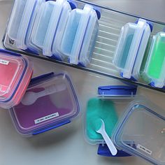 plastic containers with spoons and cleaning products in them