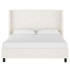 a bed with white linens and pillows on it's headboard, against a white background