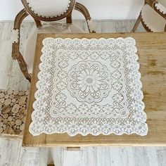 a wooden table topped with a white doily