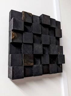 a sculpture made out of wooden blocks on the wall