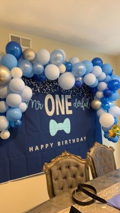 a blue and white birthday party with balloons