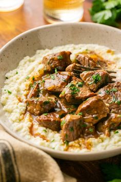 This healthier beef tips and gravy served over cauliflower mash is a nutritious and cozy twist on the classic. It's gluten-free, low carb, and can be tailored to be dairy-free. Make this guilt-free comfort dish on the stovetop or crockpot. Cheesy Mashed Cauliflower, Gf Dinner, Pepper Gravy, Beef Tips And Gravy, Gravy Ingredients, Cauliflower Mash, Arrowroot Flour, Sirloin Tips, Keto Beef Recipes