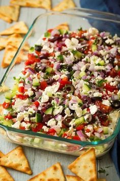 a glass dish filled with salad and crackers