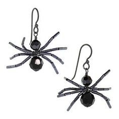 a pair of spider earrings with black beads