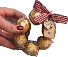 a person is holding some chocolates in their hand and tied with a ribbon around it