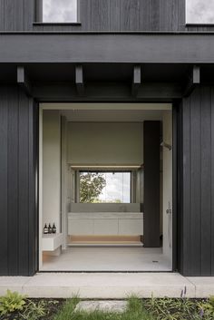 an open door leading into a black and white house