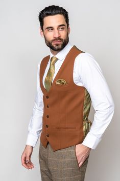 Channel traditional English gent vibes with the Ted suit. Crafted with heritage inspired wool-mix cloth, this suit adopts a herringbone weave in earthy tones and works beautifully for a country barn wedding look. The addition of the mix-and-match Kelvin waistcoat will make you stand out from the crowd. The perfect way to differentiate between groom and groomsmen. Waistcoat also available in a double-breasted option. Model wears size 40R blazer, 38R waistcoat & 34R trousers. Features Herringbone Formal Fitted Brown Tweed Jacket, Tailored Brown Tweed Suits, Tailored Suit For Groom In Fall, Tailored Fall Groom Suit, Tailored Fall Suits For Groom, Fitted Tweed Suits For Wedding, Fitted Tweed Wedding Suit, Elegant Brown Business Vest, Tailored Tweed Three-piece Wedding Suit