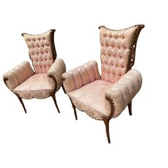 two pink velvet chairs sitting next to each other