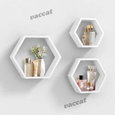 three white hexagonal shelves with different types of perfumes and bottles on them