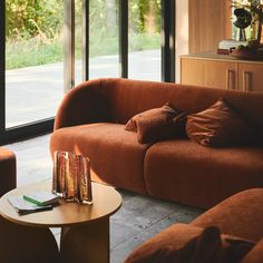 a living room with two couches and a coffee table in front of large windows