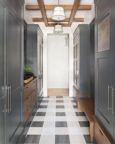 an image of a long hallway with white and black checkered flooring on the walls