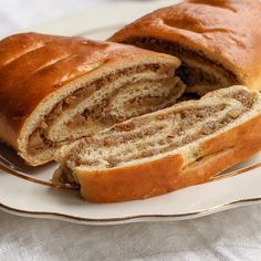 a sliced loaf of bread sitting on top of a white plate