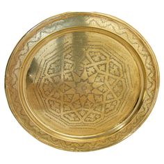 a gold plate with intricate designs on it