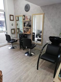 a salon with chairs and mirrors in it