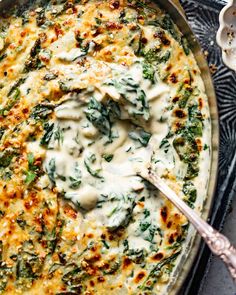 a casserole dish with spinach and cheese