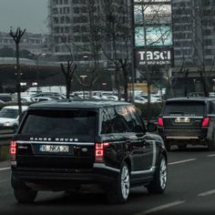 an suv driving down the road in traffic