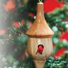 a wooden ornament with a red bird on it