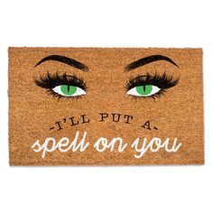 a door mat that says i'll put a spell on you with green eyes