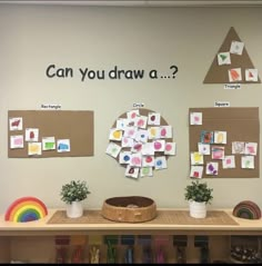 a bulletin board with post it notes and pictures on the wall next to potted plants