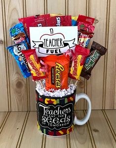 a teacher's coffee mug filled with candy and candies