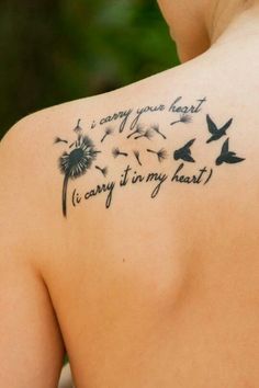 the back of a woman's shoulder with a dandelion tattoo that reads, i carry it in my heart