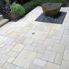 an outdoor patio with stone steps and planters