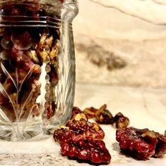 a glass jar filled with nuts and raisins