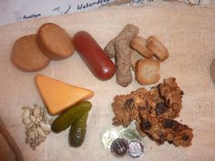 an assortment of food is displayed on a table cloth next to coins and other items