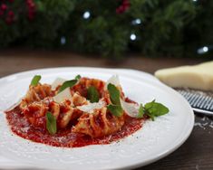 a white plate topped with ravioli and sauce