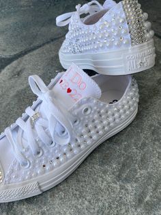 Embroidered Converse! Monochrome All WHITE Converse with pearls and rhinestones encrusted all over the shoe. ! These shoes will sparkle and get noticed across the room! They are beautifully embroidered and hand done and each pair will be a bit different. This listing shows the I Do pattern but I can put your name or monogram on them as well as the date or Mrs. Smith. Your choice. Message me your ideas! Other options available in my shop!! Wear these at your reception so your feet don't hurt. You Embellished Round Toe Wedding Shoes For Bride, Embellished Round-toe Wedding Shoes For Bride, White Embellished Low-top Wedding Shoes, Embellished White Wedding Shoes For Bridal Shower, Embellished Low-top Wedding Sneakers, White Wedding Shoes With Pearl Embroidery, Wedding White Embellished Sneakers, Low-top Wedding Shoes With Rhinestones For Bride, Low-top Bride Wedding Shoes With Rhinestones