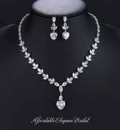 Heart CZ Bridal and Special Occasion Jewelry Set Add a romantic touch of sparkle to your wedding day look with this stunning 3A quality CZ necklace and earring set. This rhodium silver plated jewelry set glistens with brilliant marquise and teardrop shaped CZ crystals brilliantly accented with larger heart shaped cz crystals. This gorgeous jewelry set will be the perfect choice for your wedding day, quinceanera or any special occasion in need of a glamorous touch. Size: The necklace is about 17" long and the pierced earrings are about 1 1/3" long. Color: Silver/ Clear. Style: ne10988H. Please allow 3 weeks for delivery. Shipping Policy . Return Policy Winter Wedding Accessories, Diy Jewellery Designs, Veil Accessories, Wedding Jewelry Set, Bridesmaid Pearls, Special Occasion Jewelry, Pearl Jewelry Wedding, Fabulous Wedding, Vintage Inspired Jewelry