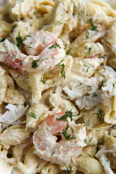 pasta salad with shrimp and dill in a white bowl