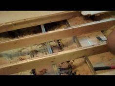 a man is working on some shelves with tools