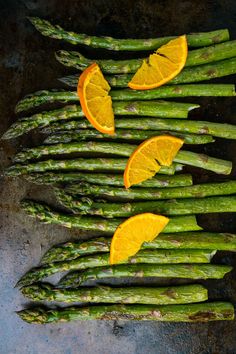 asparagus spears with orange slices on top