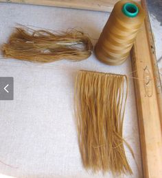 two spools of thread sitting on top of a table