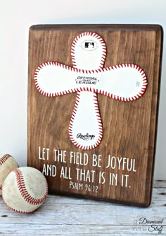 a wooden plaque with baseballs and a ball on it that says, let the field be joyful and all that is in it