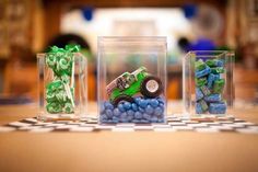 three clear containers filled with blue and green candy