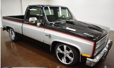 a white and black truck parked in a garage