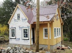 a small house under construction in the woods