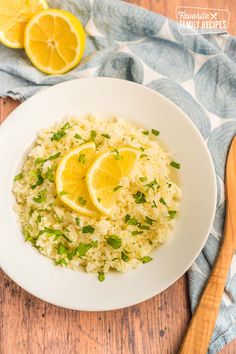 a white plate topped with rice and lemon slices