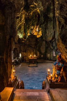 the inside of a cave with candles lit up