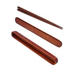 three wooden chopsticks are shown on a white background