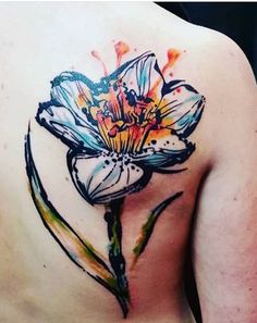 a woman with a flower tattoo on her back